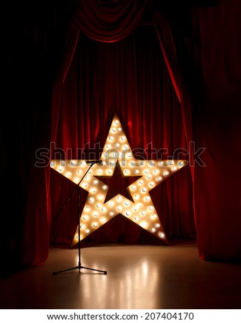 Microphone on theater stage,golden star  with red curtains around