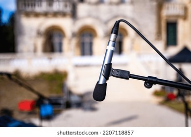 Microphone For Outdoor Music Event Festival With Old Building On Background. Electronic Speaker Closeup For Live Perfomance At Street