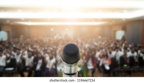 Microphone over the Abstract blurred photo of conference hall or seminar room with attendee background,Small Business training concept,Public speaking - Shutterstock ID 1196667214