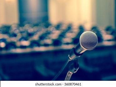 Microphone over the Abstract blurred photo of conference hall or seminar room background