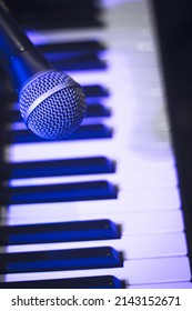 Microphone Over Piano Keys In Dim Light. No People