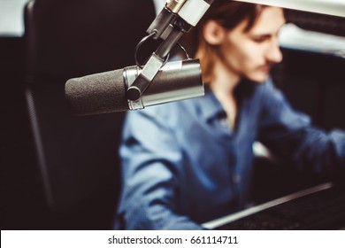 Microphone In Radio Studio And Presenter On Background