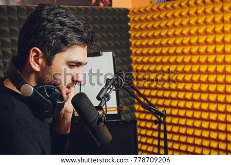 Microphone in radio studio and presenter on background