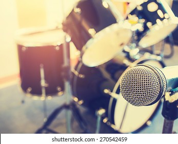 Microphone In A Recording Studio Or Concert Hall With Drum In Out Of Focus Background.  : Vintage Style And Filtered Process.