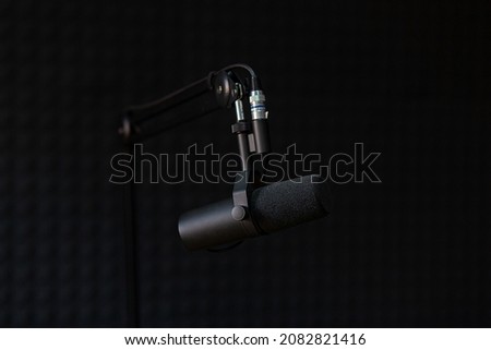 Microphone of recording studio and podcasts, on black background