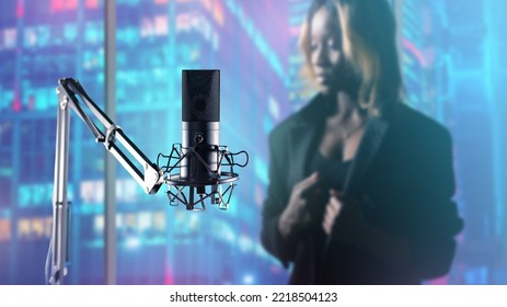 Microphone For Recording Studio. Woman Performer Of Jazz Music Blurred. Recording Studio Equipment. Professional Microphone On Steel Stand. Record Business. Recording Microphone In Studio