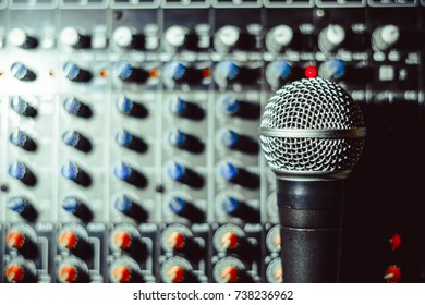 the microphone rests on an audio mixer