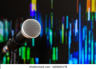 Microphone for speaker on speech in seminar room or speaking conference hall at public stage on podium convention event in light background. Comunication equipment meeting center concept