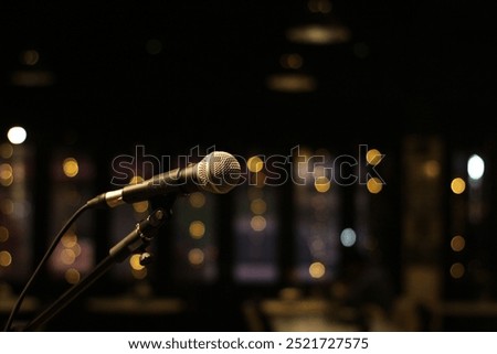 Microphone in stage, blur style for background. Microphone over the Abstract blurred photo of stage music event background