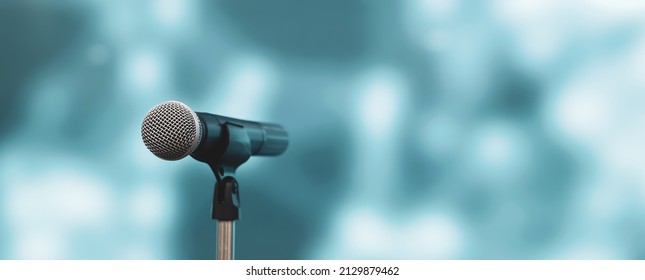 Microphone with stage light background for performance concept of speech comment and public speaking