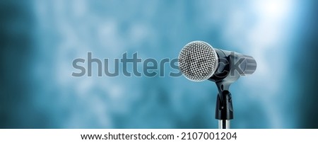 Microphone with stage light background for performance concept of speech comment and public speaking