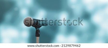 Microphone with stage light background for performance concept of speech comment and public speaking