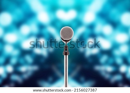 Microphone with stage light background for performance concept of speech comment and public speaking