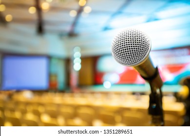 Microphone Stand Abstract Blurred Photo In Conference Hall Or Seminar Room Background, No People