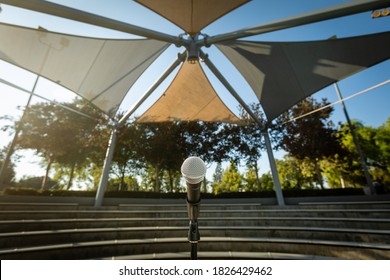 Microphone Stand In Empty Amphitheater With No People Outside At Sunset For Comedy Show Or Live Entertainment