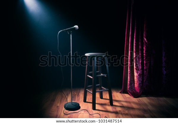 microphone and stool on a stand up comedy\
stage with reflectors ray, high contrast\
image