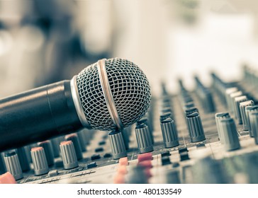Microphone voice speaker on audio synthesiser electronic music instrument sound mixer machine in broadcasting studio room, seminar event  or wedding ceremony party 