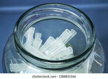 Micropipette caps in a glass jar. Labware