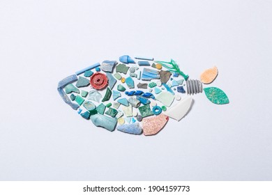 Microplastic fish on grey background 