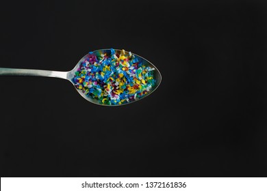 Microplastic in a glass of water on black background. Microplastic problem. Threat to human health and the environment. Dangerous additives. Toxic substances.