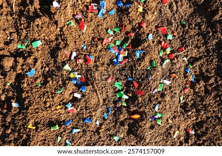 Microplastic pollution on soil. Microplastics in ground. Soil contaminated with microplastic. Plastic waste in soil, earth. Environmental, groundwater disaster. Plastic waste in hand from ground. 