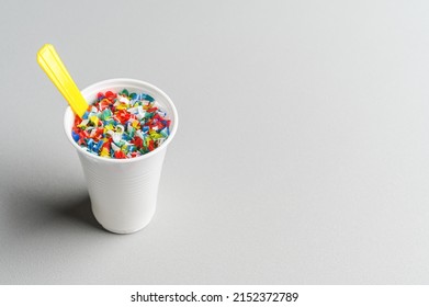 Microplastic In White Plastic Cup With Spoon. Light Grey Background. Microplastic Problem Concept. Place For Text