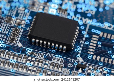 A microprocessor on a printed circuit board surrounded by auxiliary elements, backlit through the board. Macrofto in dark colors