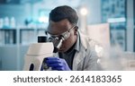 Microscope, black man and scientist in laboratory with goggles for medical research, discovery or project. Biotechnology, science and African biologist with equipment for DNA review for innovation.