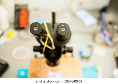 A microscope, a closeup, a workshop, a microscope for work, a black instrument