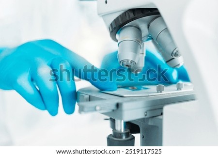 Microscope, hands or scientist with petridish for samples particles, clinical trial or chemical discovery. Person, medical science or vaccine research in lab for DNA closeup or mpox cure development