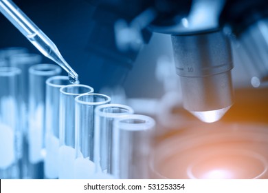 microscope with lab glassware, science laboratory research and development concept 