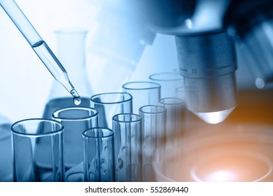 microscope with lab glassware, science laboratory research and development concept  - Shutterstock ID 552869440