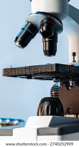 Microscope in a lab setting used for scientific observation and research tasks