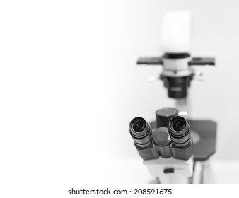 microscope in the laboratory, background with a field for text
