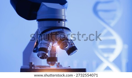 Microscope in laboratory with dna structure background, genetic engineering concept.