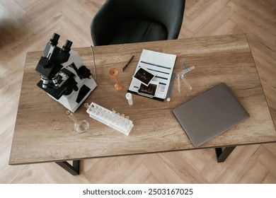 Microscope and laptop. Doctor's equipment, objects on the table.
