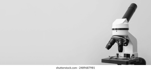 Microscope on light background with space for text