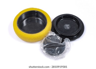 Microscope optical filter storage case with protective foam insert, black plastic lids and sealed replacement filter, isolated on white background.
