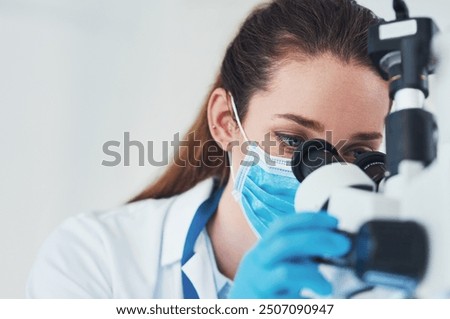 Microscope, scientist and analysis in research laboratory for medicine, biology and pharmaceuticals testing. Female person, doctor and tech with ppe mask for pathology, science and vaccine innovation