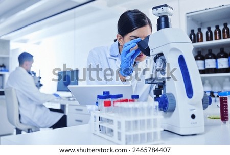 Microscope, scientist and research in lab with study for pathology, vaccine test and medical innovation. Woman, tablet and investigation with biotechnology for stem cell, science and development