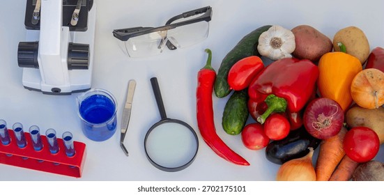 Microscope, test tubes, and fresh vegetables on a lab table for nutritional research.