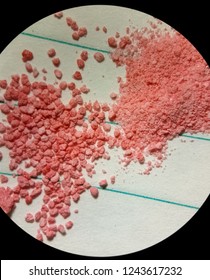 Microscope View Of A Pink Granulated Powder Material Manufactured By Pharmaceutical Technology To Make Compaction Of Tablets And Medicine Pills. Technological Process For Manufacturing In The Pharmacy