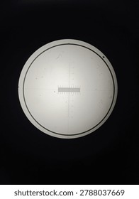 Microscopic view of a calibration slide using a biological microscope with 40x and 100x total magnification (4x and 10x objective lenses). The image shows the precise micrometer scale used to measure specimen size in laboratory research. High-quality reference images for microbiology, metrology, and scientific instrumentation.