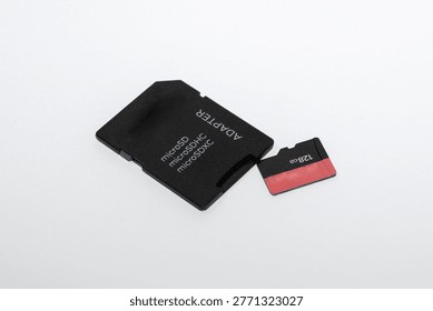 MicroSD Memory Card with SD Adapter on White Background, Digital Storage Device