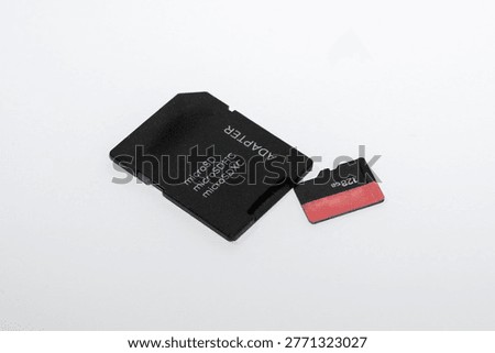 MicroSD Memory Card with SD Adapter on White Background, Digital Storage Device