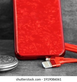 Micro-USB Data Cable For Cell Phone Battery Charging In Red Cell Phone Case Background And Gray Text Background 