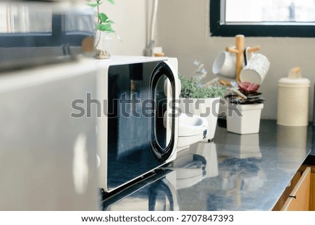 Microwave oven on the table in the kitchen at home.
