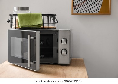 Microwave oven on wooden tabletop in modern kitchen