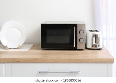 Microwave Oven With Toaster On Kitchen Table