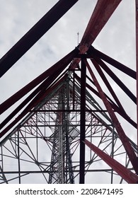 Microwave Radio Communication Tower That Towers To The Red And White Sky.